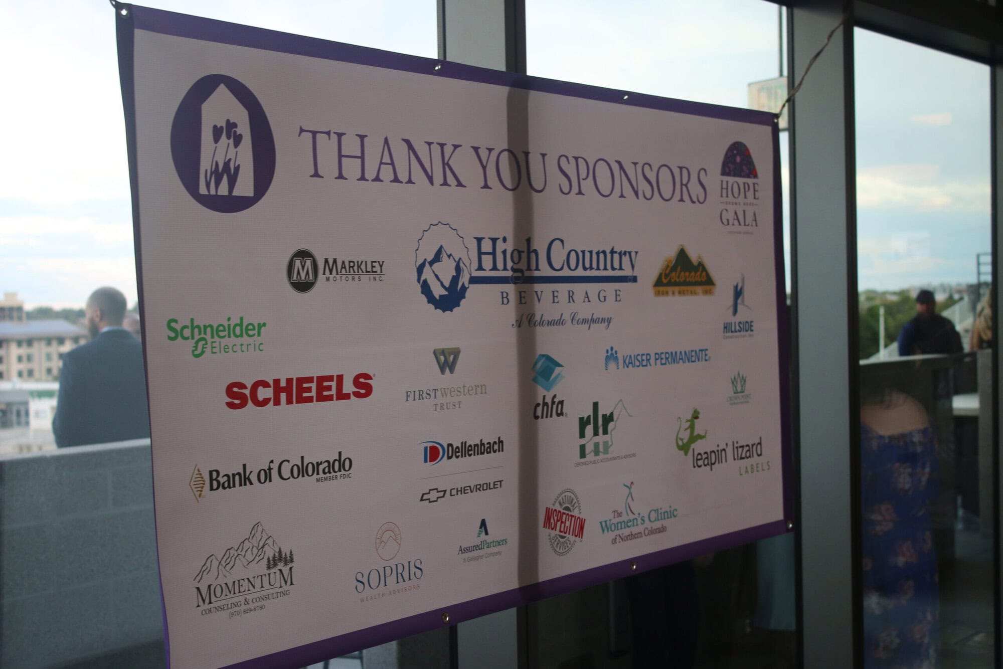 IMG_4447 A banner at an event reads "Thank You Sponsors" and displays multiple sponsor logos, including High Country Beverage, SCHEELS, Bank of Colorado, and others.