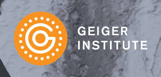 Geiger Institute logo featuring an orange circular emblem with a stylized 'G' and dotted border, next to the text "GEIGER INSTITUTE" on a gray background.