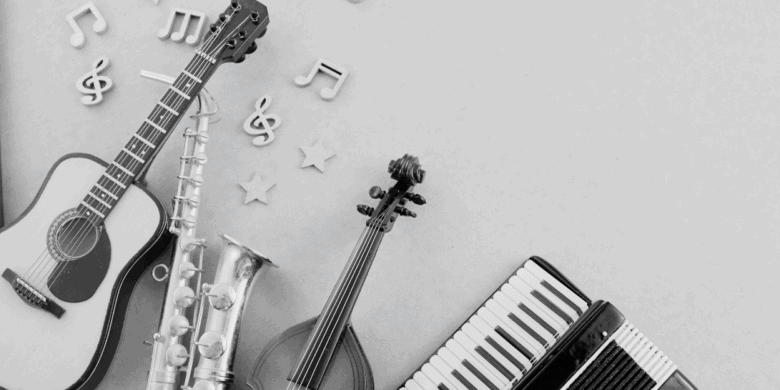 Assorted musical instruments including a guitar, keyboard, saxophone, accordion, and mandolin arranged on a light surface with musical notes and stars.