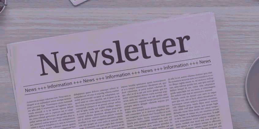 A newspaper with the headline "Newsletter" lies on a wooden table next to a coffee cup and a small potted plant.